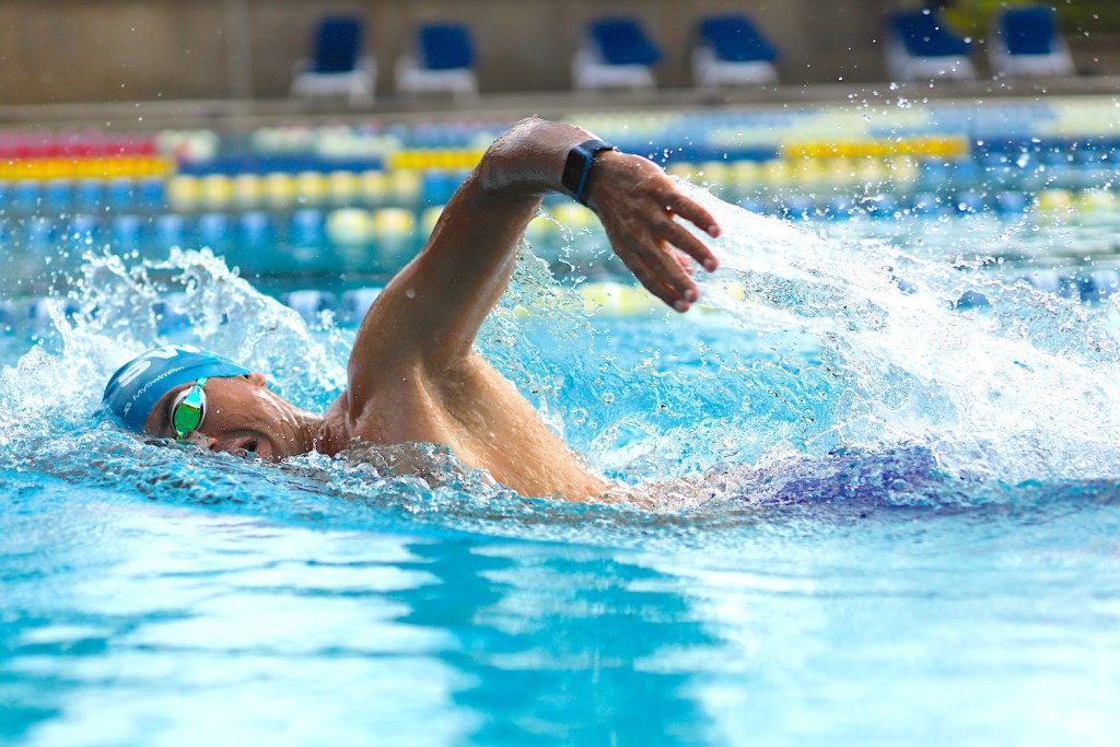 Swimmers doing freestyle in lane